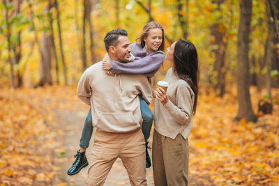 Statue of man and woman in forest during autumn