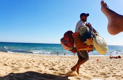 Full length of man on beach against sky
