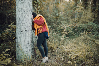 Woman walking through the forest during the day