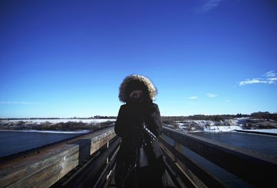 Portrait of woman standing on snow covered landscape