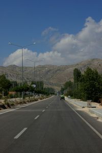Cars on road against sky
