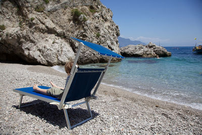 Chairs on rocks at beach