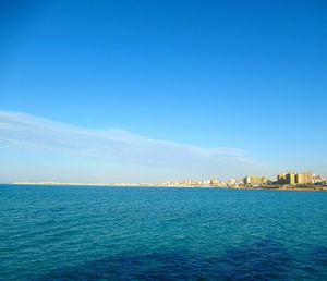 Scenic view of sea against blue sky