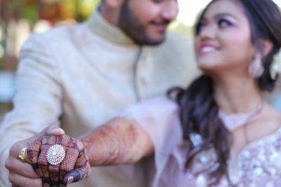 Midsection of couple holding hands