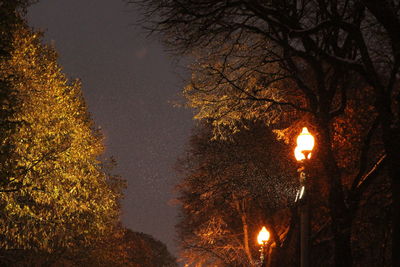 Low angle view of illuminated street light at night