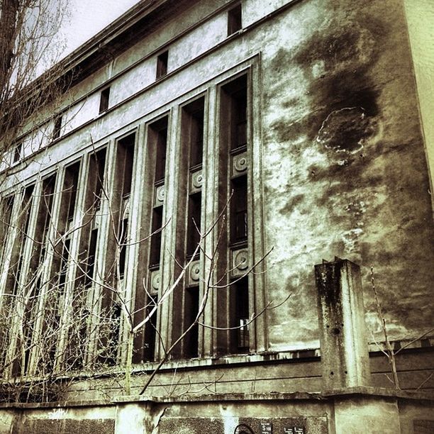 architecture, built structure, building exterior, low angle view, old, building, window, day, water, outdoors, no people, weathered, abandoned, reflection, railing, damaged, metal, run-down, sky, deterioration