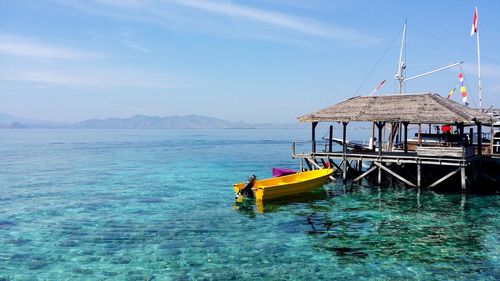 Sailboat moored on sea against sky
