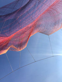 Low angle view of mobile art against blue sky