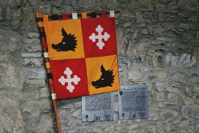 Close-up of flags against brick wall