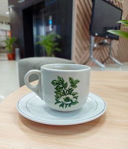 Close-up of porcelain tea cup on a wooden table