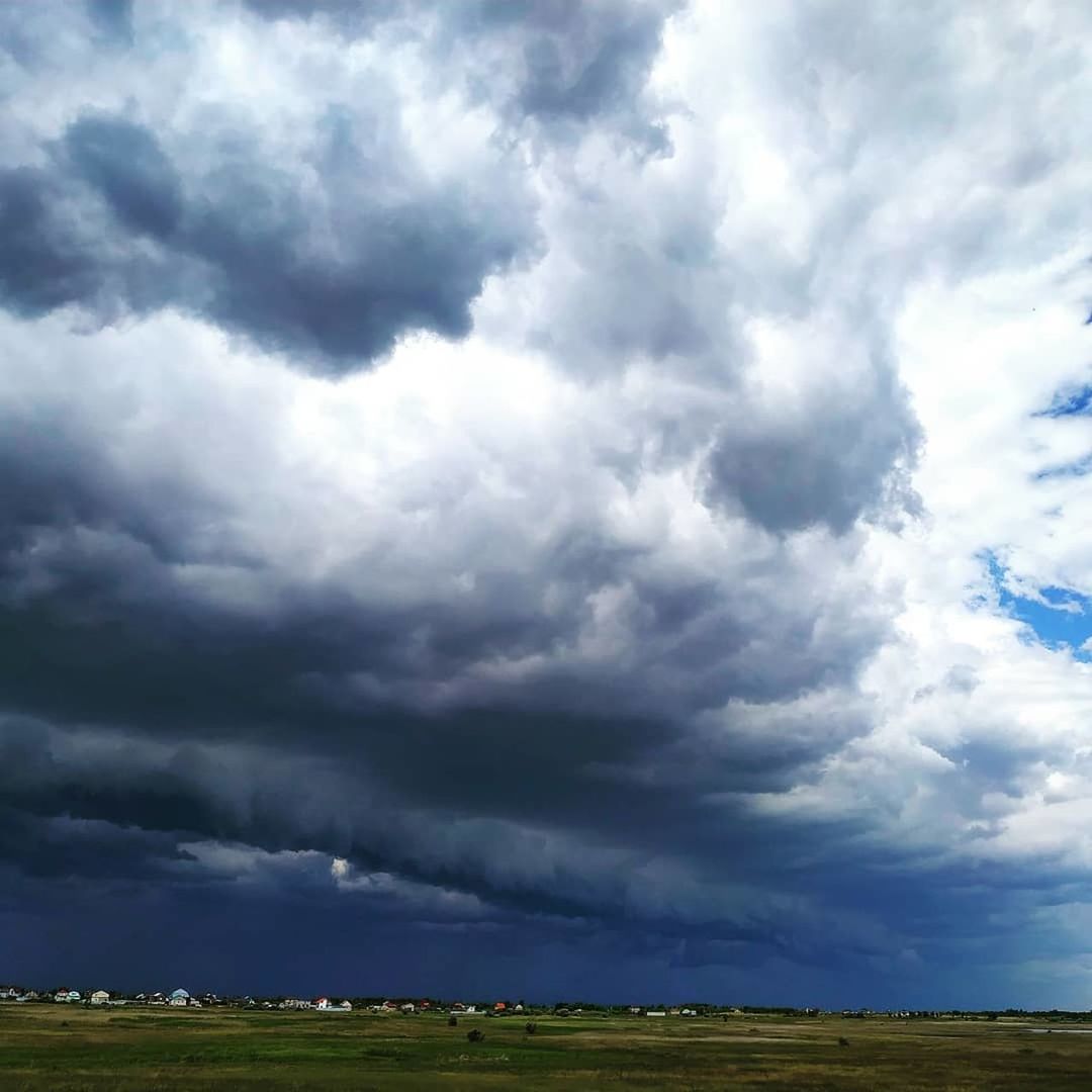 sky, cloud, environment, landscape, storm, plain, grassland, beauty in nature, nature, prairie, horizon, field, storm cloud, dramatic sky, scenics - nature, cloudscape, thunderstorm, land, no people, plant, horizon over land, overcast, grass, outdoors, rural scene, rain, day, wet, blue, awe, extreme weather, non-urban scene, sunlight