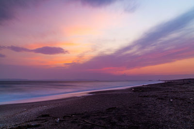 Scenic view of beach against sky during sunset