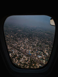 Aerial view of city seen through airplane window