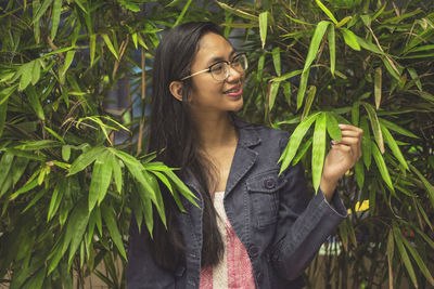 Woman standing by plants