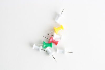 High angle view of colored pencils over white background