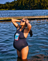 Young woman in bikini standing in water