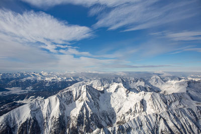 Flying over the snow-covered austrian alps. aerial view