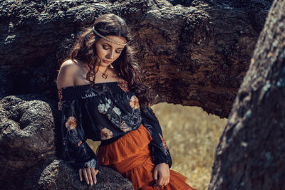 Young woman standing  amongst rocks