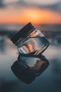 Close-up of water against sky at sunset