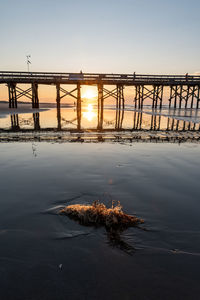 Tilt image of bridge against sky during sunset