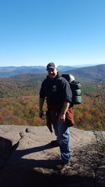 Man standing on mountain against clear sky