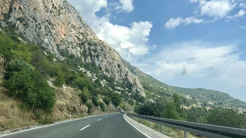 Road amidst mountains against sky