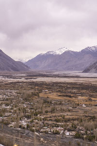 Scenic view of landscape and mountains against sky