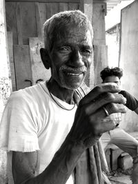 Portrait of smiling mature man holding tea cup