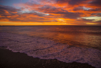 Scenic view of sea against orange sky