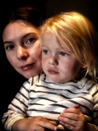 Close-up of mother and son in darkroom