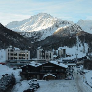 Scenic view of snow covered mountains against sky