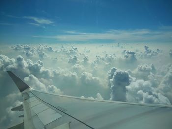 Low angle view of airplane wing against sky