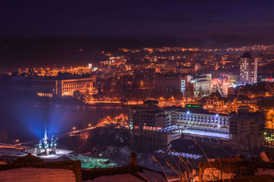 Aerial view of city lit up at night