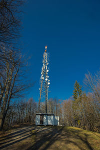 Electricity pylon on field against sky