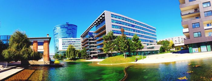 Buildings against clear blue sky