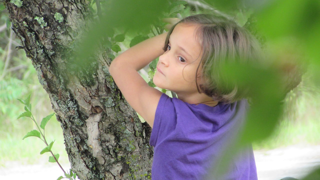 green color, young adult, plant, beauty, person, nature, outdoors, black hair, human face, contemplation, focus on foreground, beauty in nature