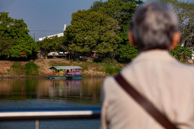 Senior woman looking at the river. non motorized ferry. 