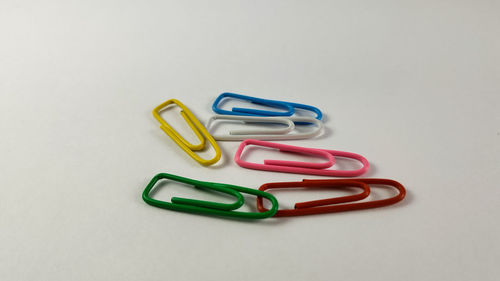 Close-up of colored pencils over white background