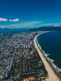 High angle view of sea and buildings against sky