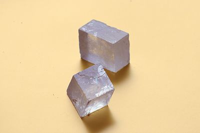 High angle view of metal on table against yellow background