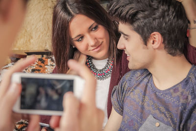 Portrait of smiling young woman using smart phone