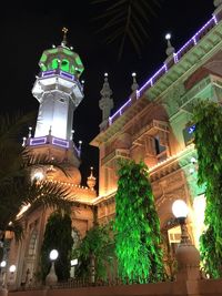 Low angle view of illuminated building at night