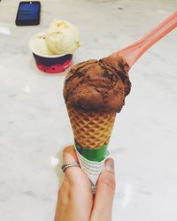 Cropped hand holding ice cream cone