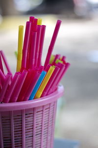 Close-up of multi colored straws in basket