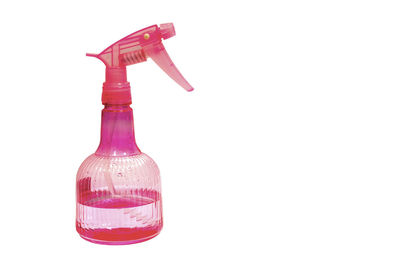 Close-up of pink bottle against white background