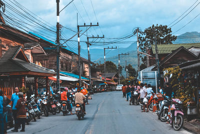 People riding bicycles on road in city