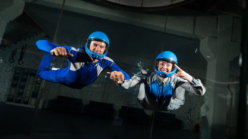 Portrait of man and woman doing indoors skydiving