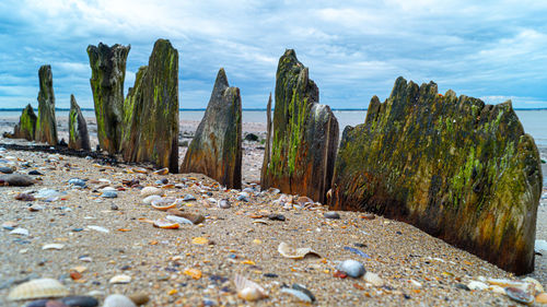 Panoramic view of rocks on beach against sky