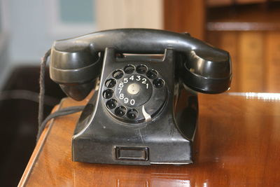 Close-up of telephone booth on table