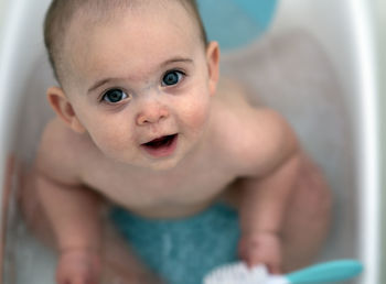 High angle portrait of cute baby in bathtub